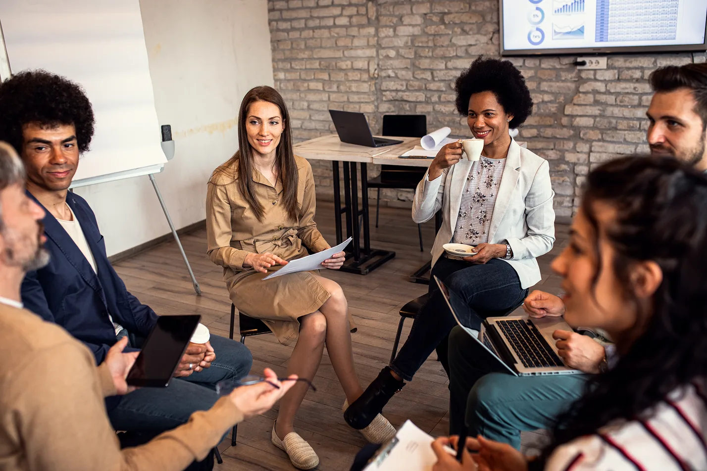 Diverse team collaborating in modern workspace during focused strategy meeting.